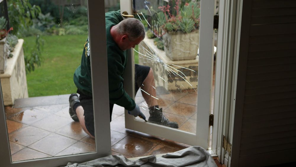An Express Glass expert technician performing an emergency glass replacement service in [state]